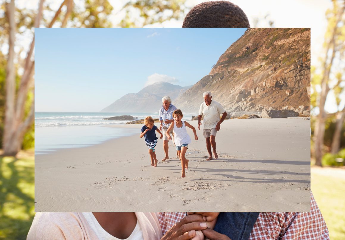 A multigenerational family running together on a beach